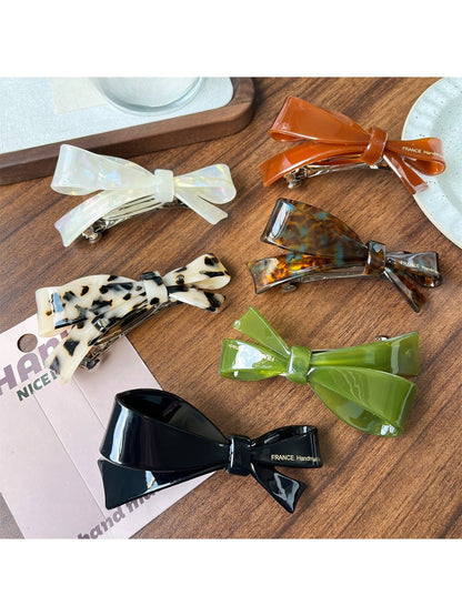 Close-up of Beau elegant bow hair clip highlighting acetate material and clasp