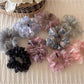 Scrunchie wrapped around a ponytail with colorful flowers