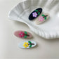 Close-up of Beau oval hair clip showing smooth curved edges and clasp mechanism