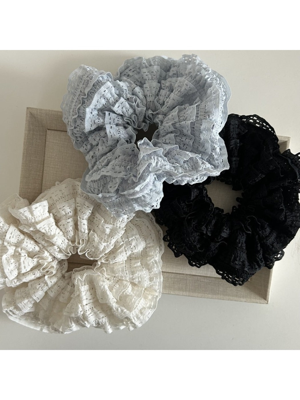 Side view of Gifty Sweet Cutout Lace Scrunchie highlighting the elastic band and lace design