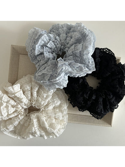 Side view of Gifty Sweet Cutout Lace Scrunchie highlighting the elastic band and lace design