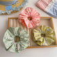 Gifty scrunchie with color block stripe print on a white background