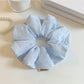 Top view of Gifty solid color striped scrunchie showing fabric texture and stripes