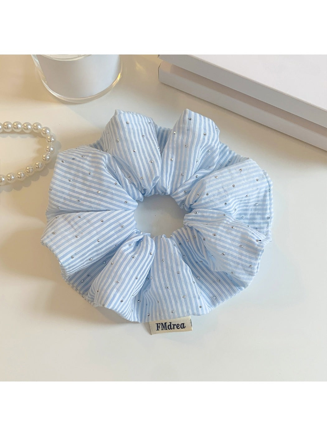 Top view of Gifty solid color striped scrunchie showing fabric texture and stripes