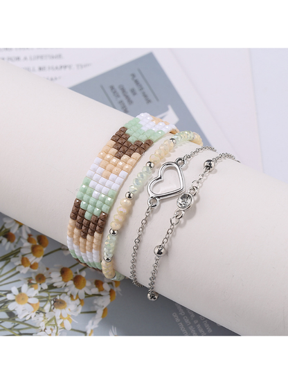 Multiple Lovra boho stackable beaded bracelets layered on a model's arm