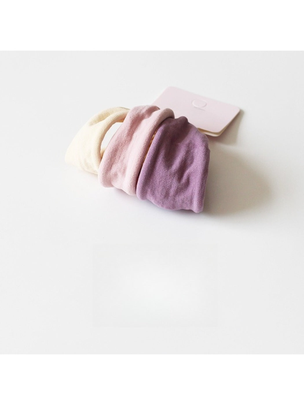Hair ties bundled together with a simple paper band packaging