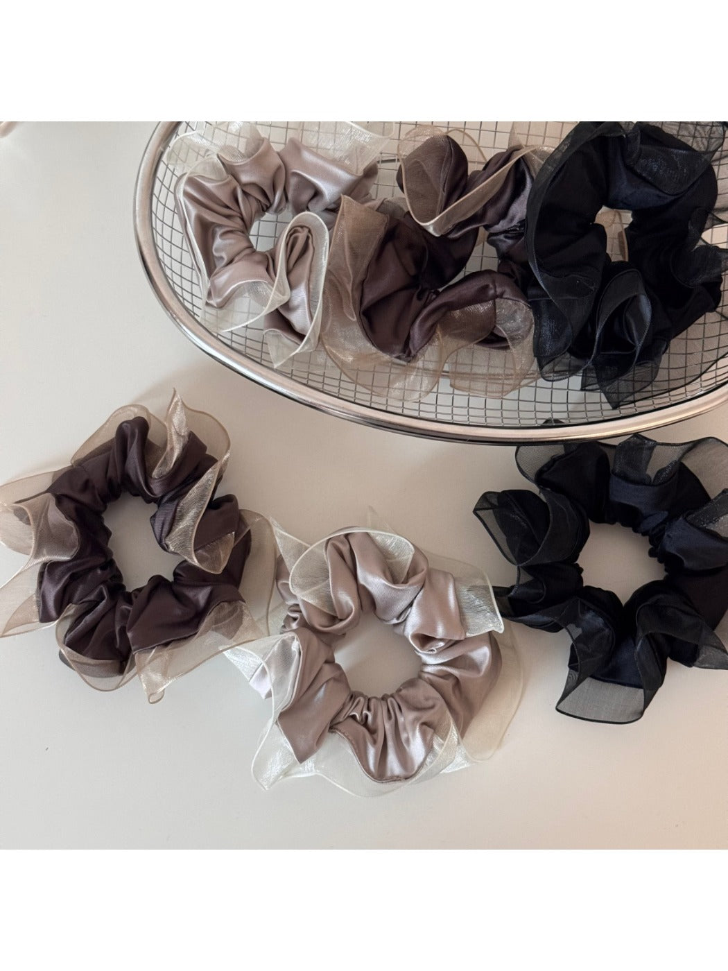 Glossy pink scrunchie with a smooth, shiny fabric texture