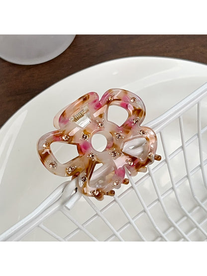 Beau flower shaped hair claw clip in soft pastel color on neutral background