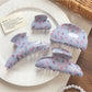 Beau blue floral print shark claw hair clip on white background