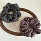 Side view of Gifty striped dark scrunchie showing fabric texture