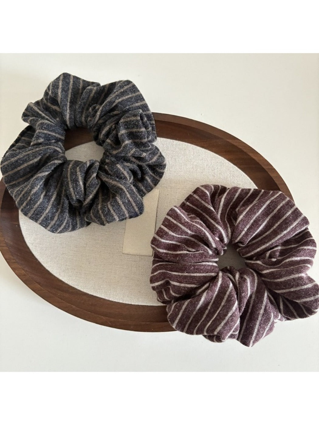 Side view of Gifty striped dark scrunchie showing fabric texture