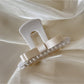 Beau T shaped bow hair claw clip shown from top angle with open clasp