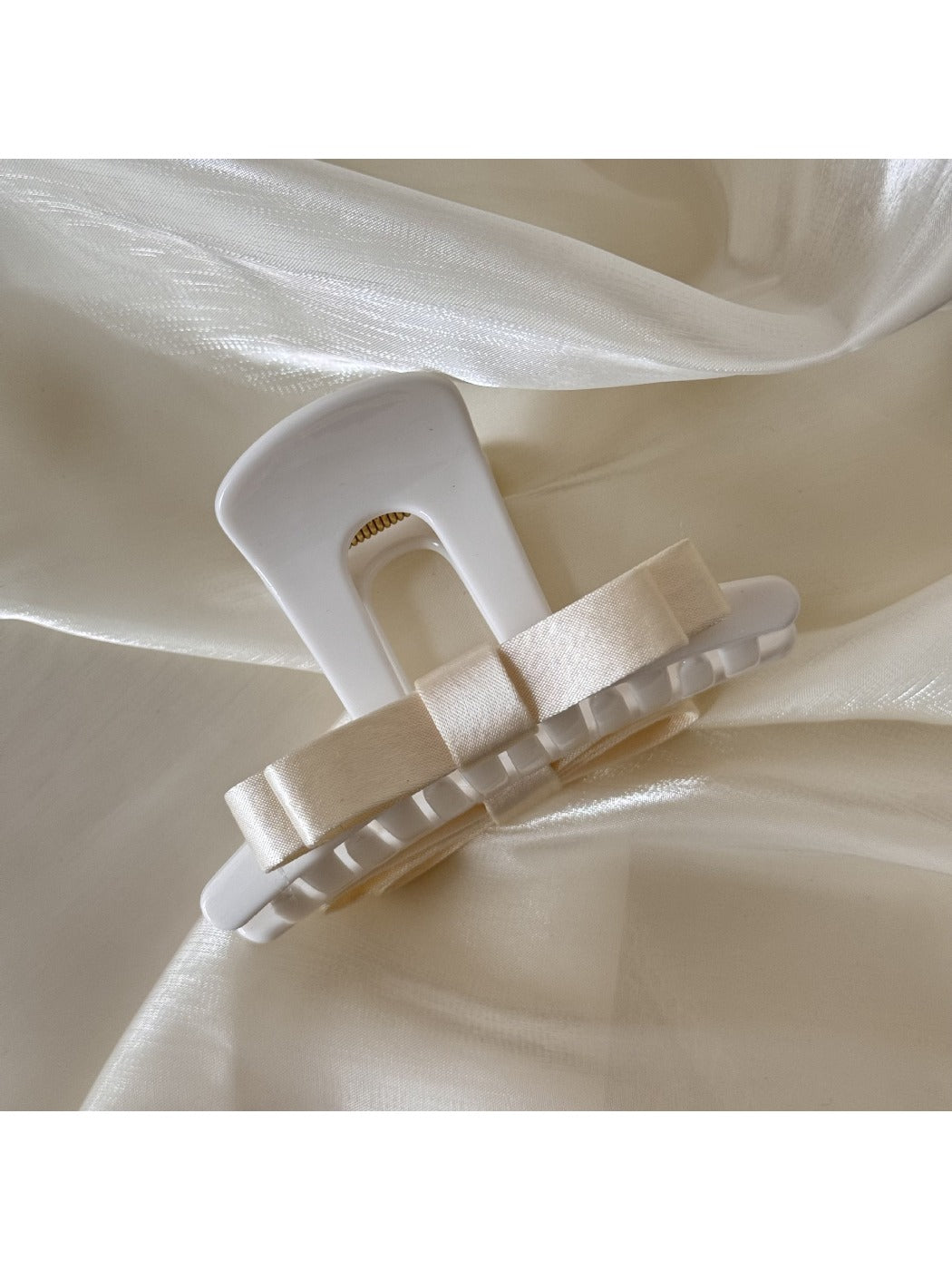 Beau T shaped bow hair claw clip shown from top angle with open clasp