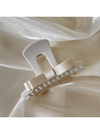 Beau T shaped bow hair claw clip shown from top angle with open clasp