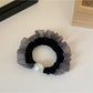 Hair ties styled in a ponytail featuring plaid and polka dot patterns