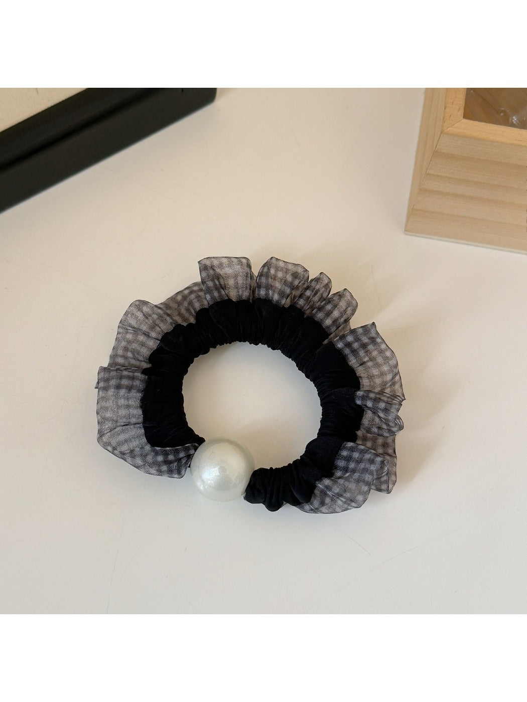 Hair ties styled in a ponytail featuring plaid and polka dot patterns