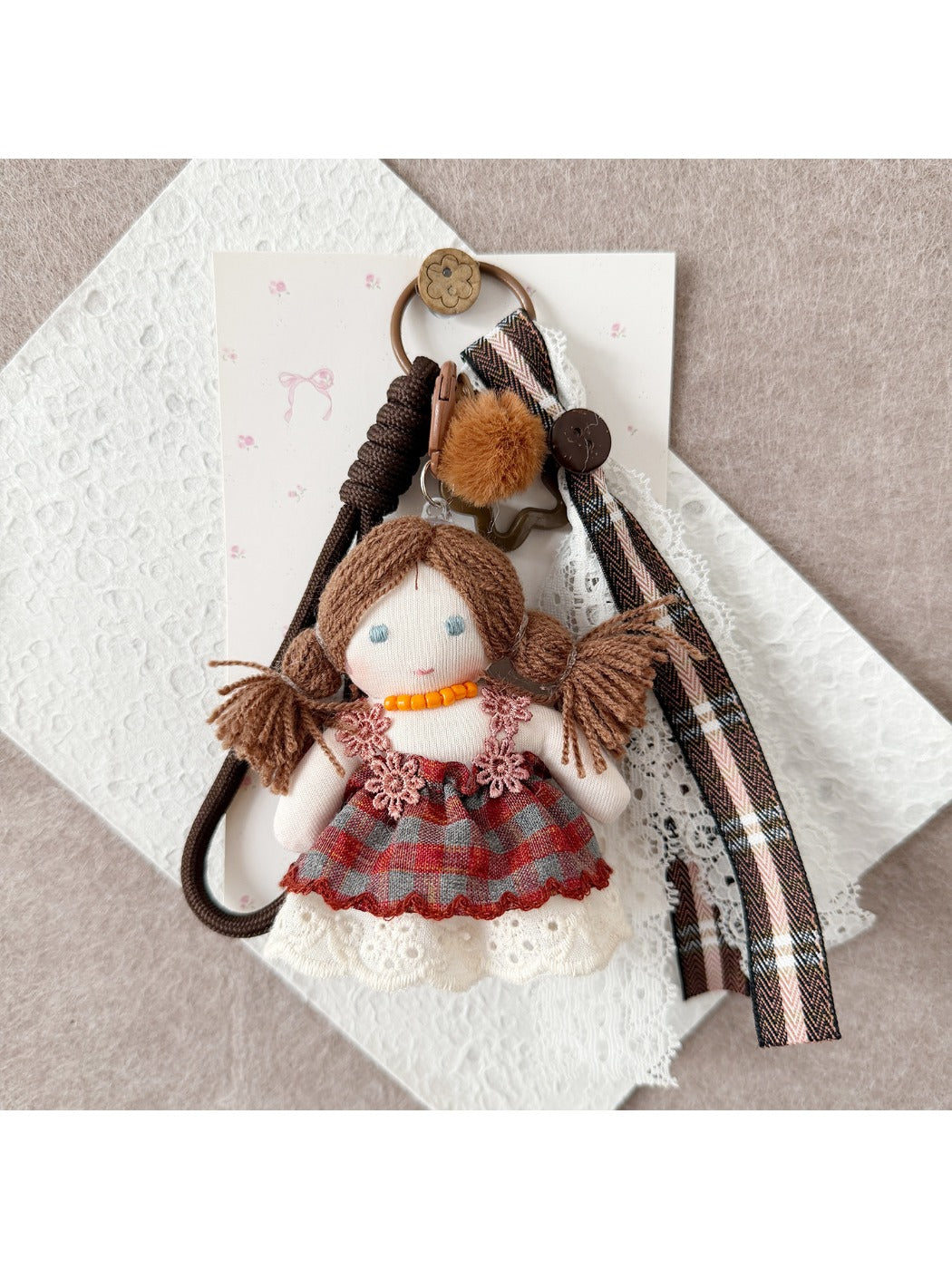 Side view of Keypus double ponytail fabric doll keychain highlighting hair and outfit