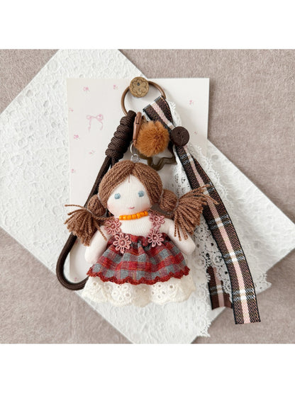 Side view of Keypus double ponytail fabric doll keychain highlighting hair and outfit