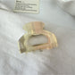 Top view of Beau semi circular claw clip showing symmetrical openwork pattern
