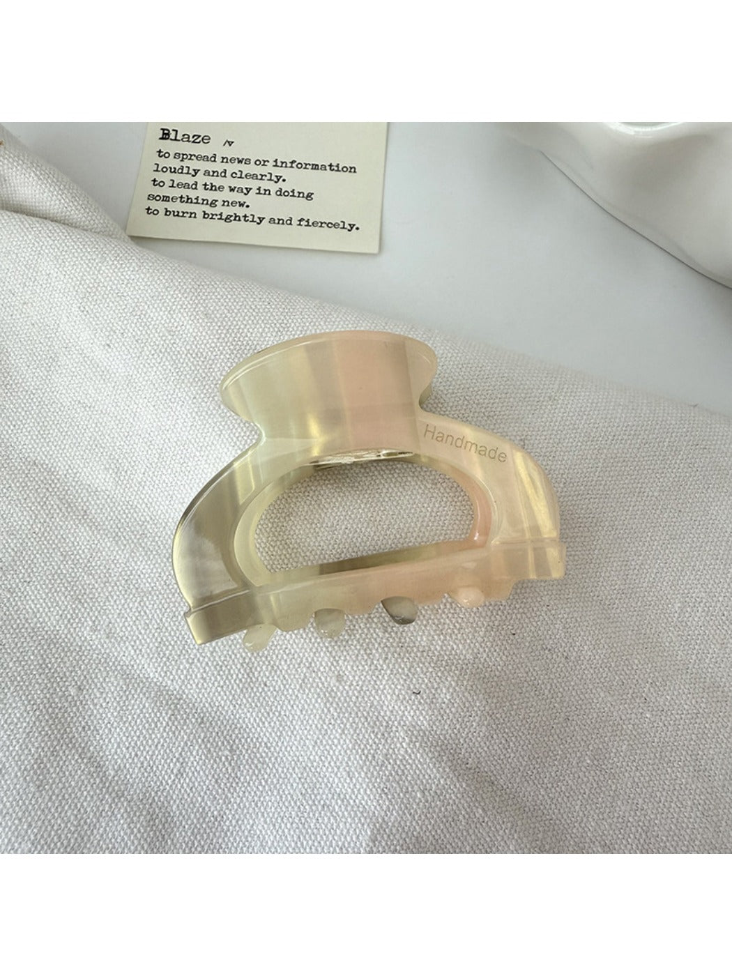 Top view of Beau semi circular claw clip showing symmetrical openwork pattern