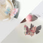 Beau butterfly claw clip resting on a wooden surface with natural lighting