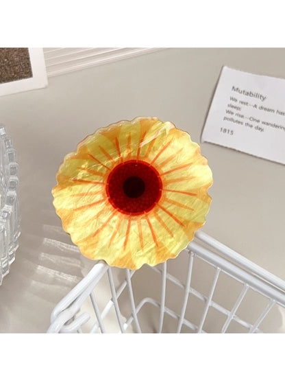 Beau flower shaped hair claw clip held in hand to show size and scale