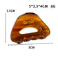 Top view of Beau minimalist hollow oval claw clip in black