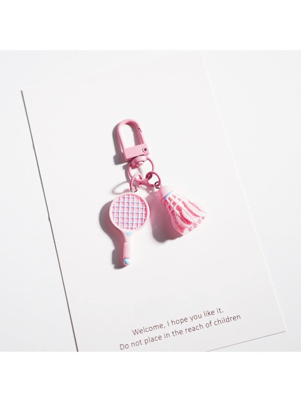 Badminton racket keychain displayed on a white background highlighting design