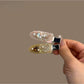Beau delicate hair clip with heart-shaped decoration on a white background