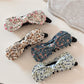 Beau oil painting style bow hair clip with blue and beige brushstroke design