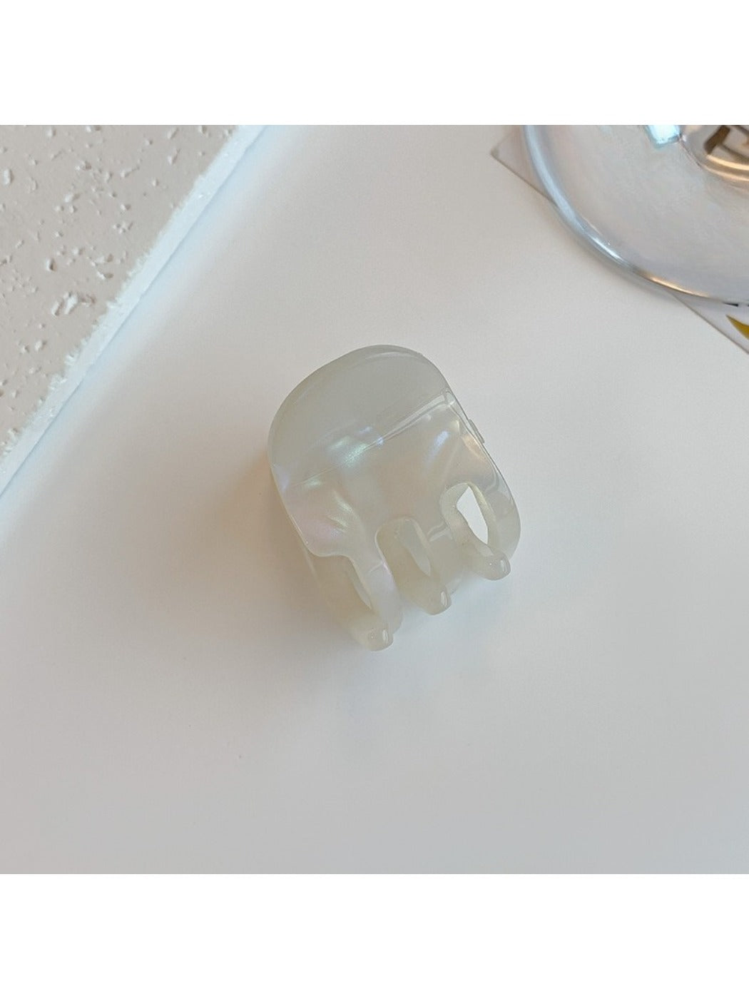 Beau hair clip held in hand demonstrating size and lightweight acetate material