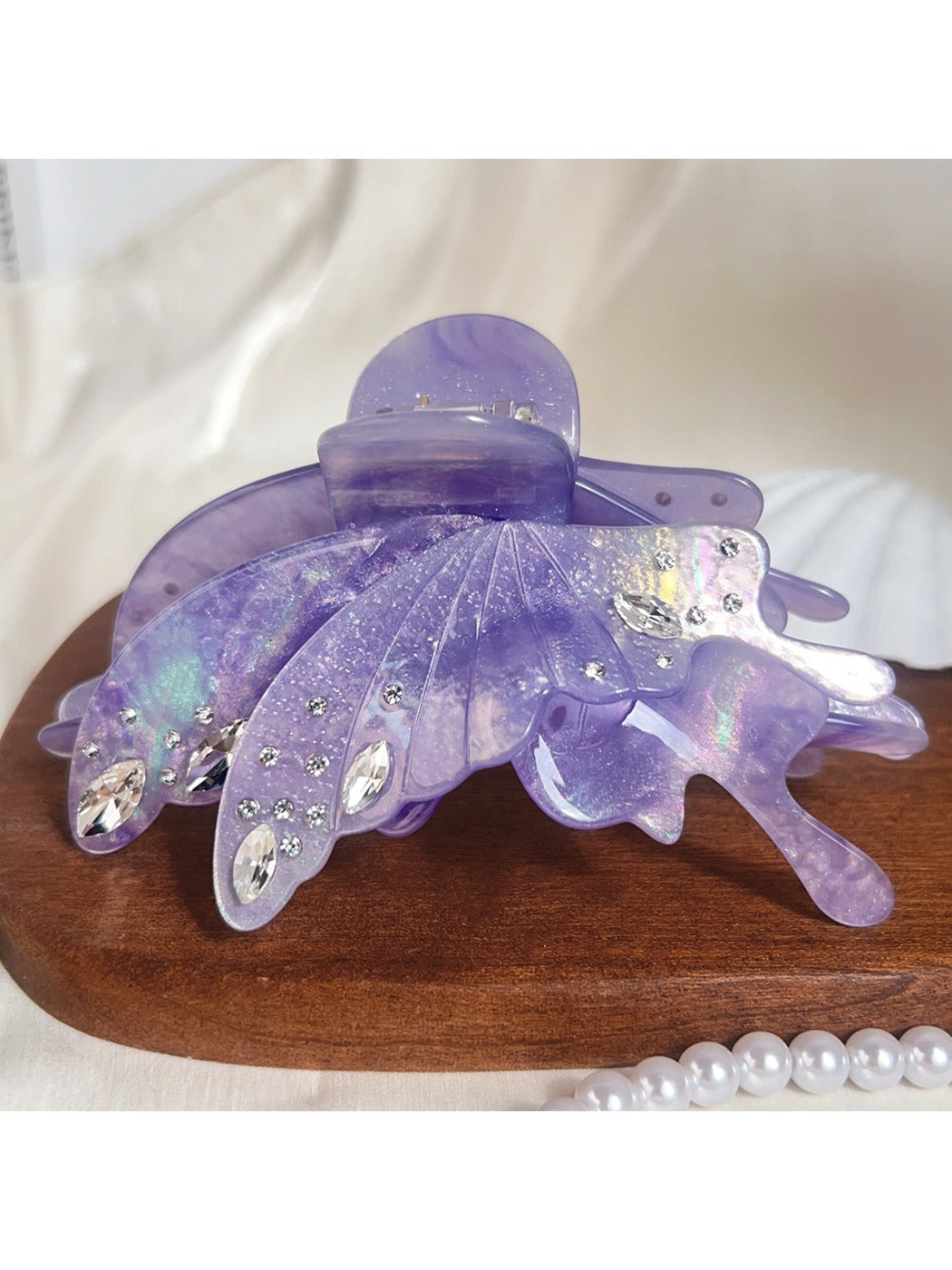 Butterfly hair claw clip holding a section of brown hair
