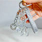 Close-up of red cherry charm on minimalist keychain with silver hardware
