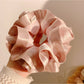 Top view of Gifty satin ruffle scrunchie showing circular shape and ruffled edges