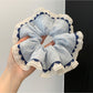 Gifty scrunchie styled on a wrist as a fashion accessory