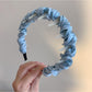 Top view of Gifty minimalist twist headband highlighting twisted design