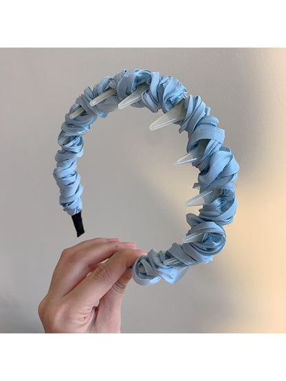 Top view of Gifty minimalist twist headband highlighting twisted design