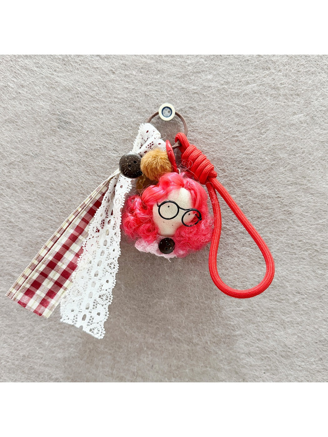 Back view of fabric curly hair doll keychain highlighting hair texture and fabric details