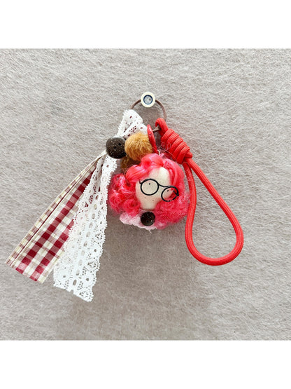 Back view of fabric curly hair doll keychain highlighting hair texture and fabric details