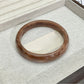 Lovra vintage ombre bangle bracelet next to green leaves for styling