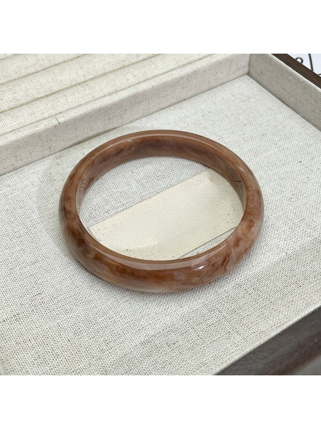 Lovra vintage ombre bangle bracelet next to green leaves for styling