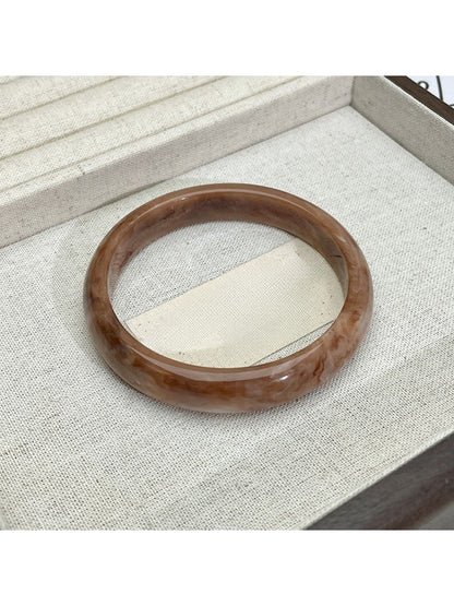 Lovra vintage ombre bangle bracelet next to green leaves for styling