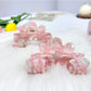 Beau wavy pink hair clip held in hand showing size and texture