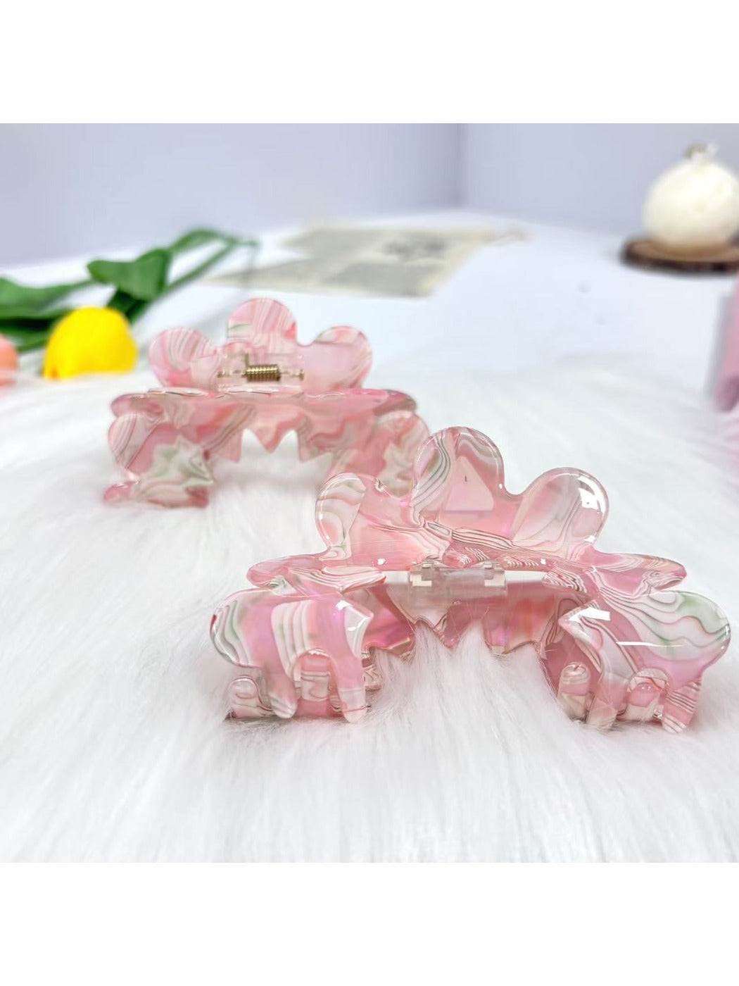 Beau wavy pink hair clip held in hand showing size and texture