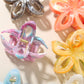 Side view of Beau flower hair clip highlighting its curved openwork pattern