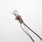 Brown tone cartoon keychain hanging on a hook in a retail setting