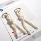 Close-up of Keypus bow made of pink beads with white accent beads on keychain
