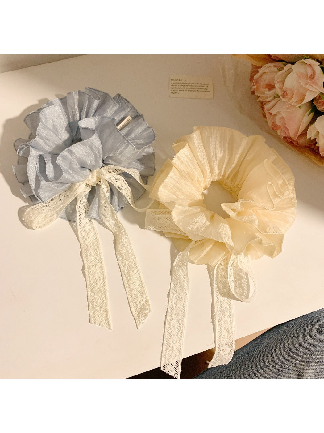 Gifty solid color bow scrunchie in soft pink fabric on white background