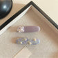 Close-up of Beau sweet purple tiny flower hair clip with delicate petals