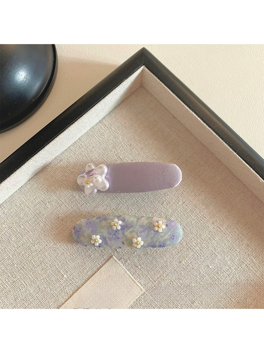 Close-up of Beau sweet purple tiny flower hair clip with delicate petals